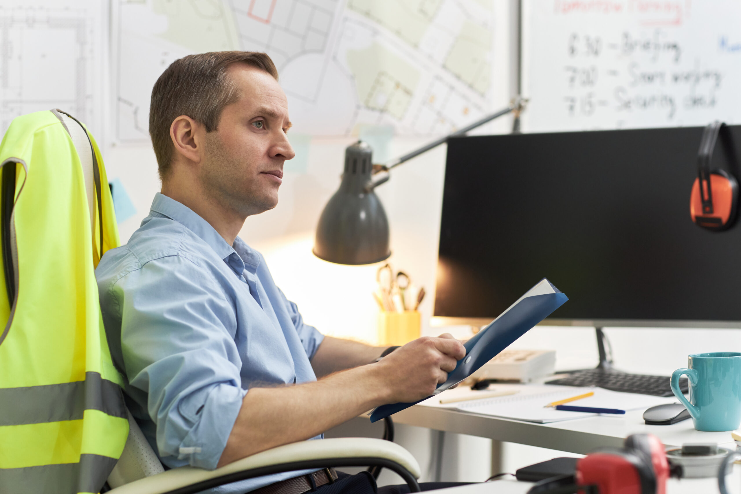 Caucasian Middle Aged Man Reviewing Documents in Office as Foreman