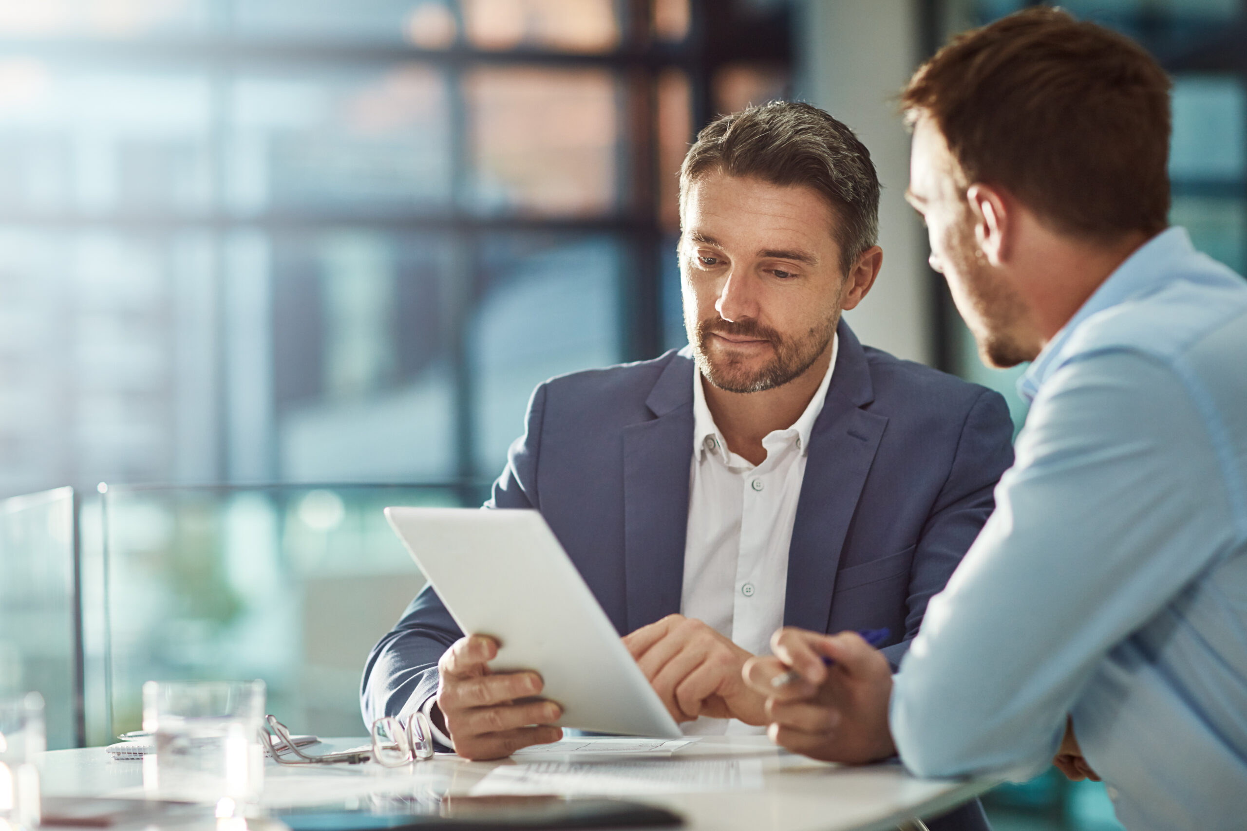 Teamwork meeting, tablet and business people in office workplace  Collaboration, technology and workers, men or employees with touchscreen planning sales, research or financial strategy in company